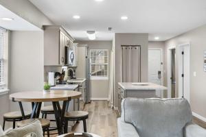 a kitchen and living room with a table and chairs at Modern Comfort Retreat in Branson +17 photos