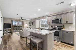 a kitchen and living room with a stove top oven at Modern Comfort Retreat in Branson