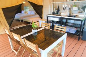 a table and chairs in a room with a couch at Canopy Villa Cay Sao in Phu Quoc +39 photos