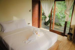 Voodi või voodid majutusasutuse Bali Secret Jungle toas