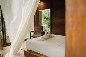 Voodi või voodid majutusasutuse Bali Secret Jungle toas