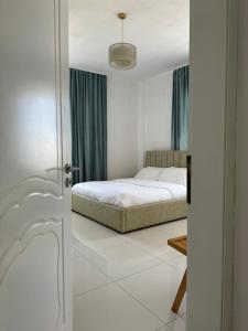 a bedroom with a bed in the middle of it at KuneVain Guest House in Lezhë