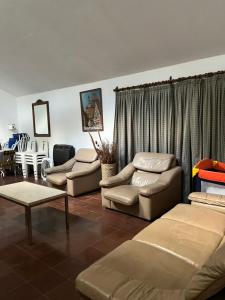 a living room with couches and a couch and a table at La Gregoria in Carpintería