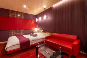 a red bedroom with a bed and a red couch at Asahikawa Hotel COLOR'S-Adult Only in Asahikawa +18 photos