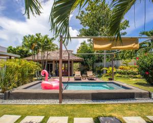 a pool with a pink flamingo in a backyard at Halamanan Residences in Panglao Island