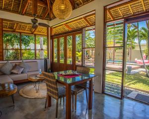 a living room with a table and chairs at Halamanan Residences in Panglao Island