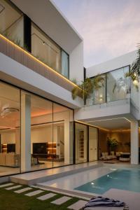 an exterior view of a house with a swimming pool at Archestet Villas Canggu in Canggu