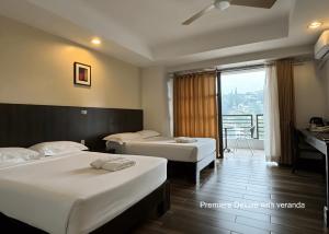 a hotel room with two beds and a balcony at Citylight Hotel in Baguio +127 photos