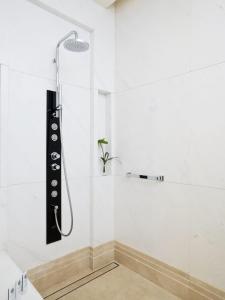 a shower in a white bathroom with a plant at The St. Regis Chengdu in Chengdu