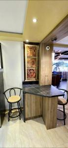 a kitchen with two chairs and a counter top at RH #4 los ángeles, elegant suite 2nd floor in San Juan