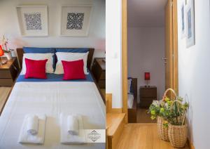 1 dormitorio con 1 cama grande con almohadas rojas en Casa da Ferreirinha, en Sistelo
