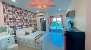 a bedroom with a bed and a ceiling fan at The Linux Garden Hotel (City Amphur Muang Yala) in Yala