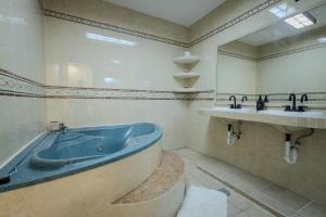 a bathroom with a large tub and a sink at BnB rooms in downtown Cancun- Casa Sunshine Cancun in Cancún