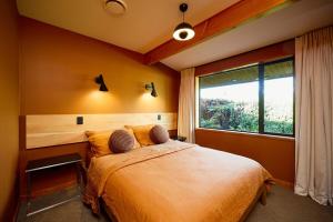 a bedroom with a large bed and a window at The Entire Mangamaunu Retreat 