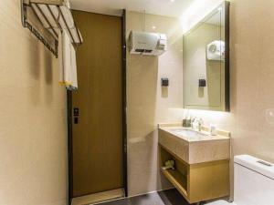a bathroom with a sink and a mirror at City Comfort Inn Liuzhou Wuling Liutai Road in Liuzhou +223 photos