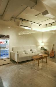 a living room with a couch and a table at Luk Hostel in Bangkok
