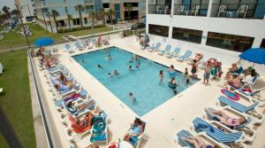 an overhead view of a swimming pool with people in chairs at Holiday Sands South in Myrtle Beach
