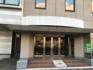 an entrance to a building with glass doors at Hotel Tetora Hachinohe in Hachinohe