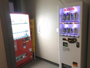 a vending machine next to a kinnikuman at Hotel Tetora Hachinohe in Hachinohe