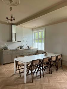 a kitchen with a white table and chairs at Historic Apartment At Karljohansvern In Horten in Horten
