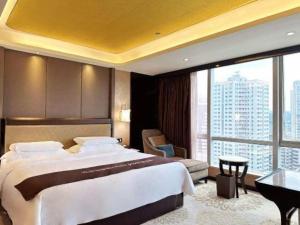 a bedroom with a large bed and a large window at Venus Royal Hotel Guangdong Meizhou Huangjia Mingdian in Meizhou +199 photos