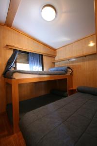 a cabin with a bed in the back of a boat at Bungalows Granja Escuela Arlanzón in Arlanzón