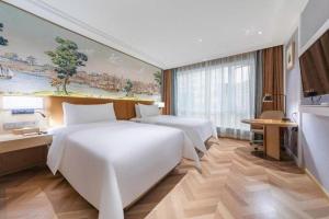 Postel nebo postele na pokoji v ubytování Vienna Hotel Guizhou Zunyi Medical School + 151 fotografií