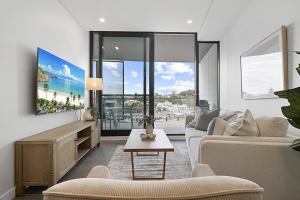 a living room with a couch and a table at Bright 1-Bedroom Escape with Private BBQ in North Fremantle