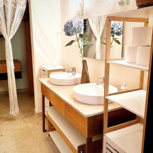 a bathroom with a sink and a mirror at #703 Pajaro de Fuego in Sayulita