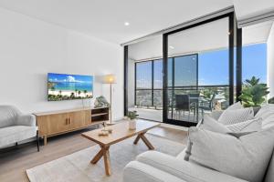 a living room with two couches and a tv at Stylish 2-Bed Unit with Views & Rooftop Access in North Fremantle