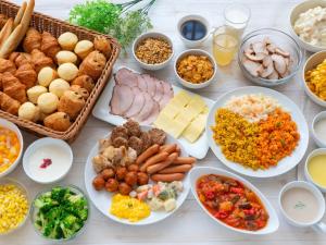a table topped with lots of different types of food at Villa Fontaine Tokyo Nihombashi Hakozaki in Tokyo