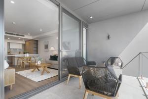 a living room with chairs and a table at Penthouse Stay With Ocean Views in North Fremantle