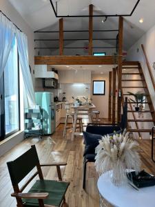 a living room with a table and chairs and a kitchen at Near JR Kameari Tokyo - Shades of Green - Japanese House for up to 6 Guests in Tokyo
