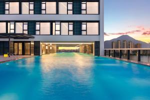 a large swimming pool in the middle of a building at Crowne Plaza Putian by IHG in Putian
