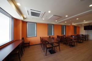 a dining room with wooden tables and chairs at Urbain Kyoto Kiyomizugojo in Kyoto