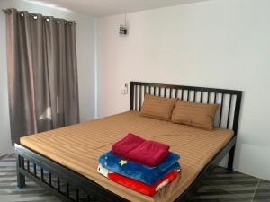 a bed with two towels on top of it at Maloop Cafe Hostel in Koh Rong Island +46 photos