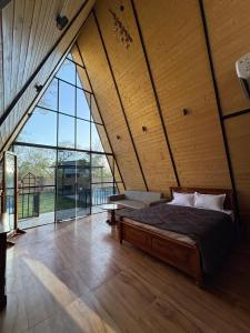 a bedroom with a bed and a large window at Dunewood Resorts in Ani +20 photos
