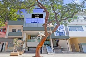 カーンプルにあるSuper Collection O Kakadeo Kanpur Formerly Hotel Avonの前に木がある建物