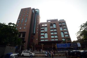 a building with a car parked in front of it at Sai Palace Grand, Malad in Mumbai