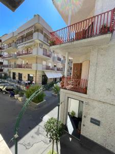 an apartment building with a balcony and a parking lot at SoverHouse affittacamere a Soverato Marina in Soverato Marina