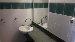 a bathroom with a sink and a shower stall at Herbert Valley Motel in Ingham