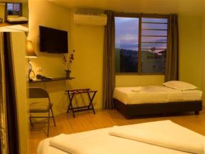 a hotel room with two beds and a window at City Center Hotel in Baguio +100 photos