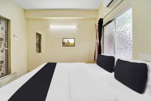 Postel nebo postele na pokoji v ubytování Super Hotel O Erode Bus Stand + 24 fotografií