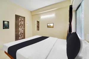 Postel nebo postele na pokoji v ubytování Super Hotel O Erode Bus Stand