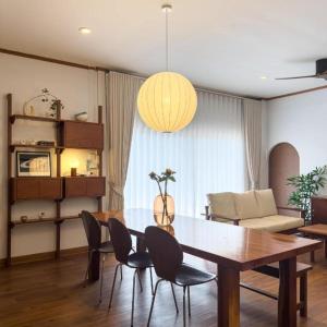 ein Wohnzimmer mit einem Holztisch und Stühlen in der Unterkunft Phutara Resort in Ban Bang Non Nai