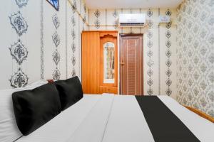Postel nebo postele na pokoji v ubytování Super Hotel O Airport Road Coimbatore