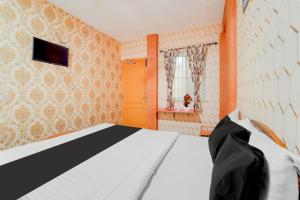 Postel nebo postele na pokoji v ubytování Super Hotel O Airport Road Coimbatore + 24 fotografií