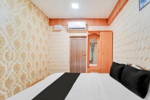 Postel nebo postele na pokoji v ubytování Super Hotel O Airport Road Coimbatore