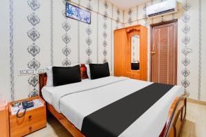 Postel nebo postele na pokoji v ubytování Super Hotel O Airport Road Coimbatore