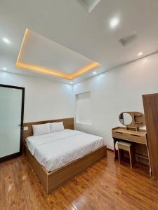 a bedroom with a bed and a desk in it at Jerry house - Private House in the City center in Hue